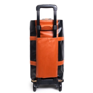 Detail of the luggage strap and silent wheels on the PU leather travel garment bag