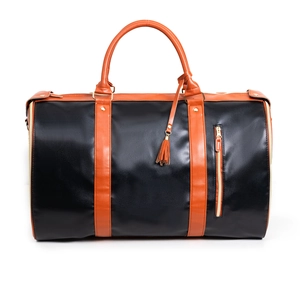 Close-up of black PU leather travel bag featuring brown straps and golden hardware zippers