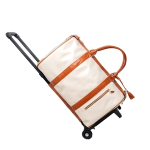 Rolling travel duffel bag in beige canvas with brown leather accents and telescopic handle