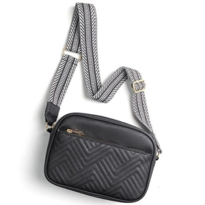 Faux leather crossbody bag in black with quilted front pocket and patterned strap