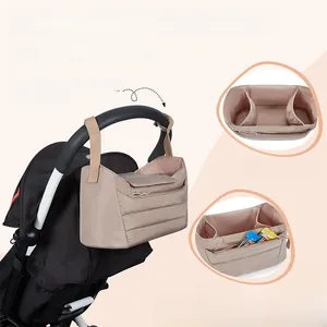 Detail view of khaki stroller organizer bag featuring interior pockets and zipper storage