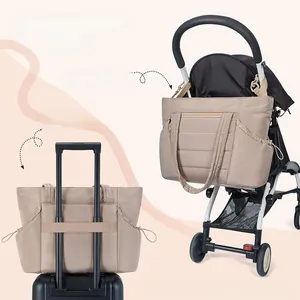 Detail view of baby diaper bag showing stroller hooks and luggage strap functionality