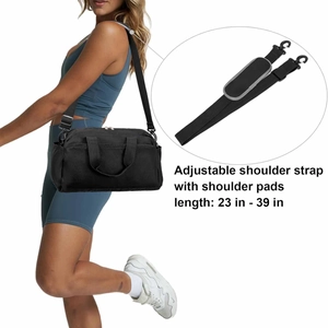 Detail showing the adjustable padded shoulder strap on a small black fitness duffel bag