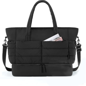 Detail view of quilted travel tote bag featuring separate bottom compartment and front pockets