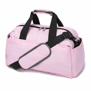 Detail view of pink gym bag with black straps and adjustable padded shoulder strap
