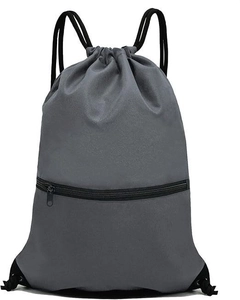 Detail view of large waterproof drawstring bag with front zipper pocket in dark grey nylon