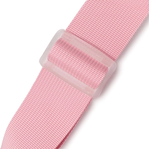 Detail of pink nylon shoulder strap with a frosted plastic slide buckle for length adjustment
