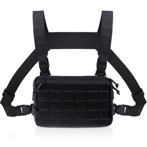 Detail of black tactical chest rig with laser-cut MOLLE system and ripstop nylon fabric