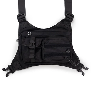 Detail of black tactical chest bag with MOLLE webbing system and carabiner hook