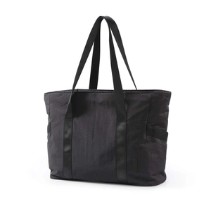 Close-up of a black high-capacity tote bag with durable nylon texture and sturdy handles
