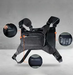 Detail view of black tactical chest bag showing main pockets and adjustable strap system