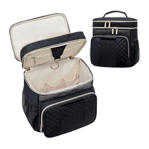 Detail of a black hanging toiletry bag featuring a metal hook and quilted fabric pattern