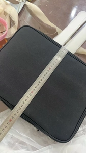 Detail view of laptop sun shade case showing length measurement of approximately 32.5cm
