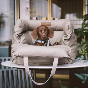 Detail of waterproof quilted leather pet car seat with metallic hooks and wide handles