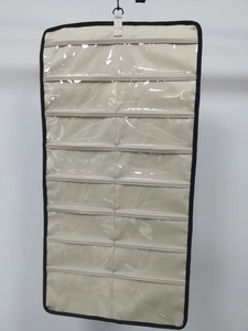 Detail of wall-mounted organizer with 20 clear PVC pockets and white canvas fabric