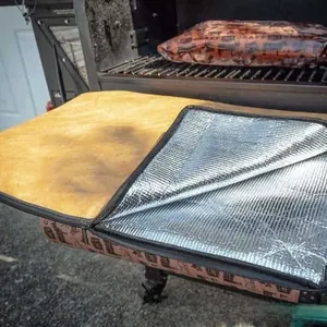 Detail of insulated BBQ cooler bag with silver aluminum lining and leather exterior
