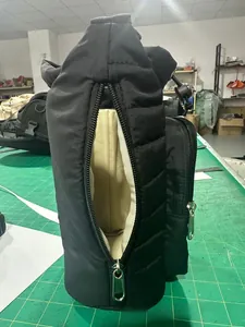 Close-up of black quilted water bottle bag with zipper pouch and drawstring cord