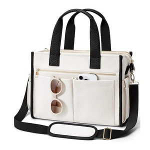 White canvas tote bag with black straps and adjustable shoulder strap for teachers
