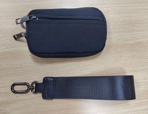 Close-up of waterproof nylon wallet with double zipper compartments and wrist strap