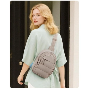 Detail view of grey quilted crossbody bag showing soft nylon texture and adjustable strap