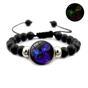 Luminous Aquarius zodiac bracelet with black matte beads and glowing glass pendant