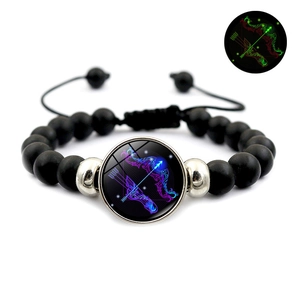 Detailed view of black beaded Sagittarius zodiac bracelet with luminous glowing effect