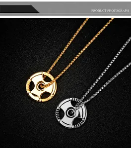 Detailed macro view of barbell weight plate pendants in gold and silver finish