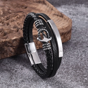 Close-up of multilayer black woven leather bracelet with silver anchor and magnetic clasp