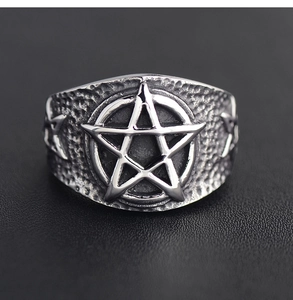 Macro detail of retro stainless steel punk ring featuring embossed star and hammered texture