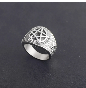 Macro shot of punk style stainless steel ring featuring a large star relief detail