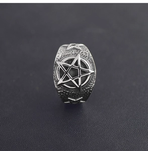 Detail of vintage stainless steel pentagram ring with textured hammered finish for men