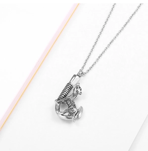 Detailed view of dog cremation pendant with antique silver finish and screw cap closure