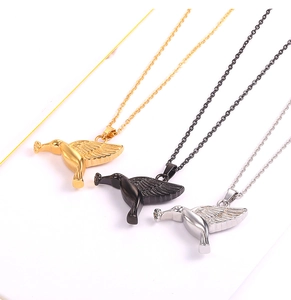 Detailed view of hummingbird pendant necklaces in gold, black, and silver steel
