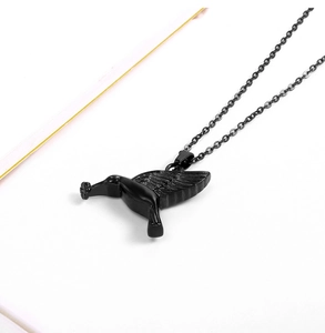 Close-up of a matte black hummingbird pendant necklace made of durable stainless steel