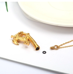 Detailed view of the gold pet cremation pendant with a rotating screw and seal ring
