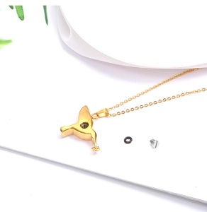 Detail of hummingbird urn necklace with screw opening and rubber seal for ashes