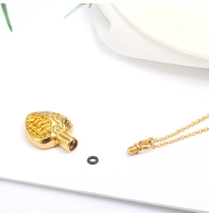 Detail of heart cremation pendant components with crystal inlay and secure seal