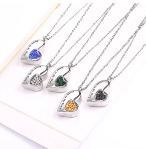 Macro view of heart-shaped crystal perfume bottle pendants in five vibrant colors