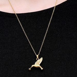 Polished hummingbird pendant necklace in gold finish with delicate feather details
