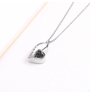Detail view of heart-shaped stainless steel pendant with Forever In My Heart engraving