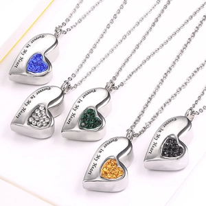 Five heart-shaped cremation urn necklaces in various colors with Forever In My Heart engraving
