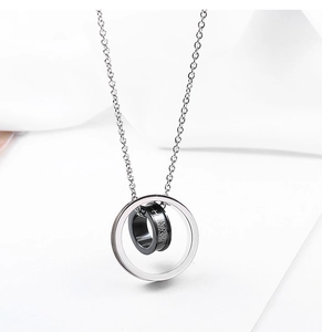 Detailed macro view of the double-ring pendant with cross engraving on titanium steel chain