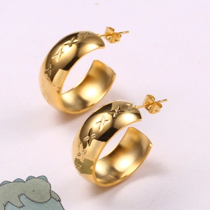 Golden C-shaped stainless steel hoop earrings with engraved star patterns for women