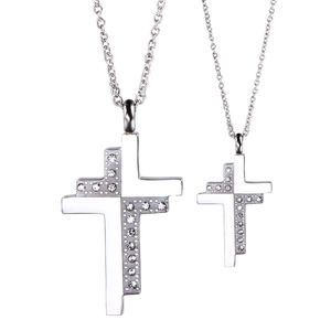 Stainless steel cross pendant necklaces with sparkling diamonds for couples set on white background