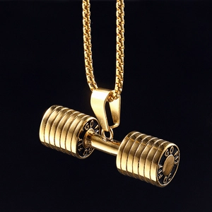 Golden stainless steel fitness dumbbell pendant necklace with GO FIT engraving on black background