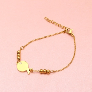 Detail of a golden fish pendant bracelet with crystal inlay and adjustable chain links