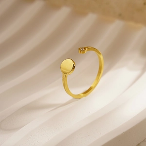 Minimalist gold adjustable open ring with a small round zircon stone on a stylish wavy base