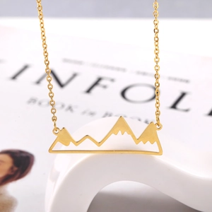 Macro shot of 18K gold plated necklace featuring a minimalist hollow mountain peak pendant