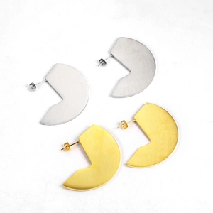 Minimalist geometric gold and silver fan shaped earrings with a brushed metal finish