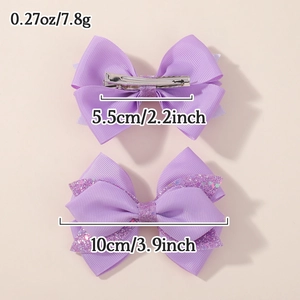 Set of two purple glitter bow hair clips for girls featuring metal alligator clip detail